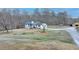 Aerial view of a two story home with a large front yard, mature trees and barn at 2885 Green Rd, Loganville, GA 30052