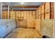 Interior of a horse stall featuring wooden walls, metal bars, and sawdust flooring at 2885 Green Rd, Loganville, GA 30052