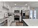 Bright kitchen with white cabinets and stainless steel appliances at 2885 Green Rd, Loganville, GA 30052
