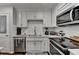 Kitchen featuring white cabinets and stainless steel appliances at 2885 Green Rd, Loganville, GA 30052