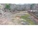 Aerial view of a large lot surrounded by mature trees with some perimeter fencing at 2885 Green Rd, Loganville, GA 30052