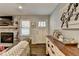 Cozy living room features a stone fireplace, hardwood floors, and stylish decor with a horse theme at 2885 Green Rd, Loganville, GA 30052