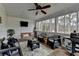 Charming screened porch featuring ceiling fan, porch swing, and comfortable wicker seating at 2885 Green Rd, Loganville, GA 30052