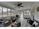 Charming screened porch featuring ceiling fan, porch swing, and comfortable wicker seating at 2885 Green Rd, Loganville, GA 30052