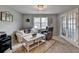 Comfortable sitting area with natural light, with a white sofa and rug, providing a relaxing ambiance at 2885 Green Rd, Loganville, GA 30052