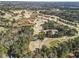 Aerial view of beautiful home situated on a golf course surrounded by trees and ponds at 4178 Castle Pines Ct, Tucker, GA 30084