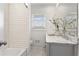 Bathroom featuring double sink with marble countertop and white subway tile at 4178 Castle Pines Ct, Tucker, GA 30084