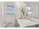Bathroom features white marble countertops, a double sink, and a vase of white flowers at 4178 Castle Pines Ct, Tucker, GA 30084