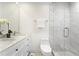 Modern bathroom features a double sink vanity, a walk-in shower with white tile and glass at 4178 Castle Pines Ct, Tucker, GA 30084
