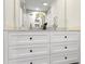 Close-up of the bathroom vanity with marble countertops, white drawers, and floral decor at 4178 Castle Pines Ct, Tucker, GA 30084