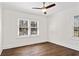 Bright bedroom with hardwood floors, large windows, and a ceiling fan at 4178 Castle Pines Ct, Tucker, GA 30084