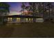 Charming single-story home with white brick exterior, landscaped lawn, and a dark roof at sunset at 4178 Castle Pines Ct, Tucker, GA 30084