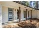 Charming front porch featuring a modern blue door, brick columns, and a cozy entrance, enhancing curb appeal at 4178 Castle Pines Ct, Tucker, GA 30084