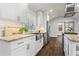 Modern kitchen boasts white cabinets, granite countertops, stainless steel appliances, and hardwood floors at 4178 Castle Pines Ct, Tucker, GA 30084