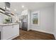 Well-lit kitchen with stainless steel appliances, granite countertops, white cabinets and hardwood floors at 4178 Castle Pines Ct, Tucker, GA 30084