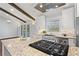 Bright kitchen features granite countertops, stainless steel appliances, and a large island with a cooktop at 4178 Castle Pines Ct, Tucker, GA 30084
