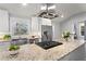Modern kitchen featuring granite countertops, stainless steel appliances, a stylish range hood, and ample natural light through the window at 4178 Castle Pines Ct, Tucker, GA 30084