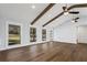 Sunny living room features hardwood floors and three windows at 4178 Castle Pines Ct, Tucker, GA 30084