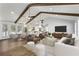 Bright open-concept living area featuring high ceilings, exposed wood beams, and modern furnishings with seamless kitchen access at 4178 Castle Pines Ct, Tucker, GA 30084