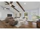 Inviting living room with hardwood floors, vaulted ceilings with beams, and large windows offering natural light and outdoor views at 4178 Castle Pines Ct, Tucker, GA 30084