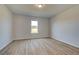 Bright bedroom with wood floors and a window offering a pleasant view at 612 Sidney Ct, Stockbridge, GA 30281