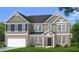 Charming two-story home with a brick facade, well-manicured lawn and integrated two-car garage at 612 Sidney Ct, Stockbridge, GA 30281