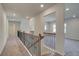 Upstairs hallway with iron railing, natural light, and views to other rooms at 612 Sidney Ct, Stockbridge, GA 30281
