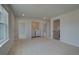 Bright, carpeted landing area with laundry closet and open doorway to another room at 612 Sidney Ct, Stockbridge, GA 30281