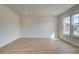 Spacious living room features wood floors and natural light from large windows at 612 Sidney Ct, Stockbridge, GA 30281
