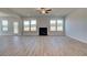 Spacious living room with a fireplace, wood floors, and views of the backyard at 612 Sidney Ct, Stockbridge, GA 30281