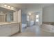 Bright main bathroom featuring tiled floors, a freestanding tub, dual sinks, and a separate tiled shower at 612 Sidney Ct, Stockbridge, GA 30281