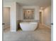 Luxurious main bathroom with freestanding tub, tiled floors, and a separate tiled shower at 612 Sidney Ct, Stockbridge, GA 30281