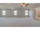 Large carpeted main bedroom features a ceiling fan, tray ceiling, and plenty of room for furniture at 612 Sidney Ct, Stockbridge, GA 30281
