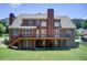 Spacious brick home featuring a large deck overlooking a lush backyard at 737 Heritage Post Ln, Grayson, GA 30017