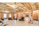 Unfinished basement showcasing exposed beams, insulation, windows, and stairs at 737 Heritage Post Ln, Grayson, GA 30017