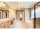 Luxurious bathroom with dual vanities, a soaking tub, separate shower, and tile flooring at 737 Heritage Post Ln, Grayson, GA 30017