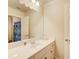 Neutral bathroom showcasing a white vanity with a mirror, cabinets and door at 737 Heritage Post Ln, Grayson, GA 30017