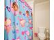 Bright bathroom featuring a Doc McStuffins shower curtain and white toilet at 737 Heritage Post Ln, Grayson, GA 30017