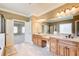 Elegant bathroom featuring dual vanities, stylish fixtures, and access to a Primary bedroom and separate shower at 737 Heritage Post Ln, Grayson, GA 30017