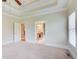 Bright bedroom featuring soft carpet, an exit door, and a door leading to an ensuite bath at 737 Heritage Post Ln, Grayson, GA 30017