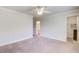 Spacious bedroom with neutral carpet, a ceiling fan, closet and an ensuite bathroom at 737 Heritage Post Ln, Grayson, GA 30017