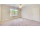 Sunny bedroom with neutral carpet, a ceiling fan, and a large window at 737 Heritage Post Ln, Grayson, GA 30017