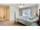 Bedroom showcasing a bed, neutral carpet, and an ensuite bathroom at 737 Heritage Post Ln, Grayson, GA 30017
