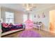 Charming bedroom with a cozy rug, play tent, ceiling fan, and large windows at 737 Heritage Post Ln, Grayson, GA 30017