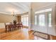 Formal dining room featuring hardwood floors, elegant chandelier, and ample natural light at 737 Heritage Post Ln, Grayson, GA 30017