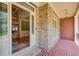 Inviting foyer with brick flooring and stone accent wall, leading to hardwood floors at 737 Heritage Post Ln, Grayson, GA 30017