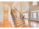 Welcoming foyer with hardwood floors, staircase with wrought iron railings, and a glass front door at 737 Heritage Post Ln, Grayson, GA 30017
