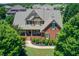Beautiful brick home with manicured landscaping and a welcoming front porch at 737 Heritage Post Ln, Grayson, GA 30017