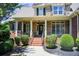 Charming front porch with stone accents, brick steps, and meticulously manicured landscaping at 737 Heritage Post Ln, Grayson, GA 30017
