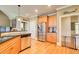 Well-lit kitchen features stainless steel appliances, granite countertops, and hardwood floors at 737 Heritage Post Ln, Grayson, GA 30017
